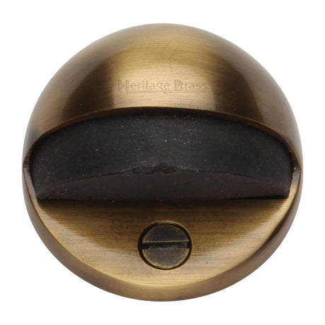 This is an image of a Heritage Brass - Shielded Door Stop Antique Brass Finish, v1080-at that is available to order from T.H Wiggans Ironmongery in Kendal.