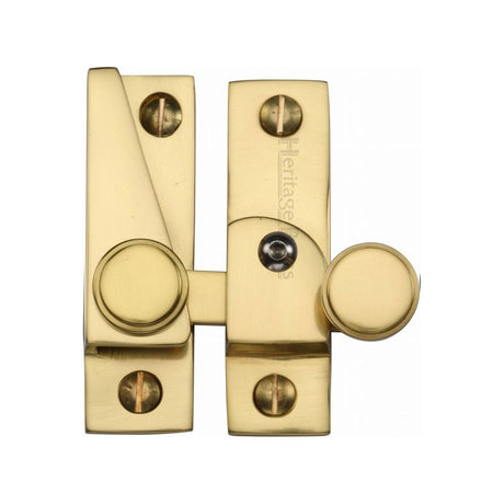 This is an image of a Heritage Brass - Sash Fastener Lockable Polished Brass Finish, v1106l-pb that is available to order from T.H Wiggans Ironmongery in Kendal.
