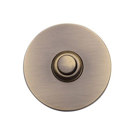 This is an image of a Heritage Brass - Round Bell Push Antique Brass finish, v1184-at that is available to order from T.H Wiggans Ironmongery in Kendal.