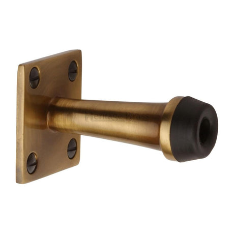 This is an image of a Heritage Brass - Wall Mounted Door Stop 2 1/2" Antique Brass Finish, v1190-at that is available to order from T.H Wiggans Ironmongery in Kendal.