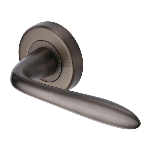 This is an image of a Heritage Brass - Door Handle Lever Latch on Round Rose Sutton Design Matt Bronze, v1750-mb that is available to order from T.H Wiggans Ironmongery in Kendal.