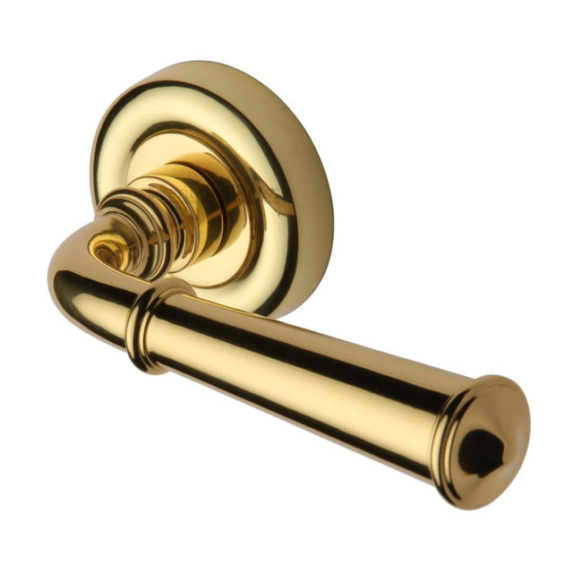 This is an image of a Heritage Brass - Door Handle Lever Latch on Round Rose Colonial Design Polished Bras, v1932-pb that is available to order from T.H Wiggans Ironmongery in Kendal.