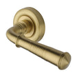 This is an image of a Heritage Brass - Door Handle Lever Latch on Round Rose Colonial Reeded Design Sa, v1936-sb that is available to order from T.H Wiggans Ironmongery in Kendal.