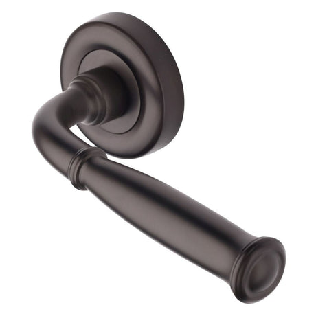This is an image of a Heritage Brass - Door Handle Lever Latch on Round Rose Lincoln Design Matt Bronz, v1938-mb that is available to order from T.H Wiggans Ironmongery in Kendal.