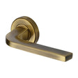 This is an image of a Heritage Brass - Door Handle Lever on Rose Bellagio Design Antique Brass Finish, v2015-at that is available to order from T.H Wiggans Ironmongery in Kendal.