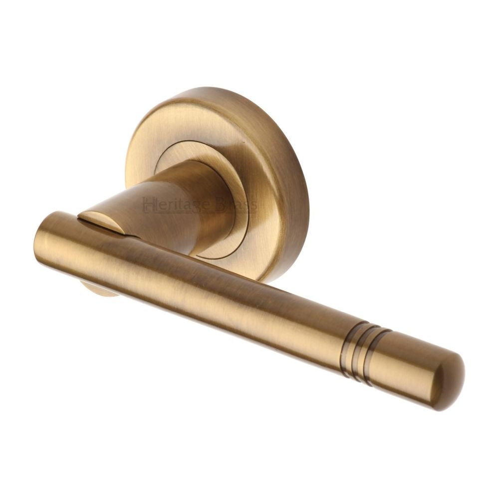 This is an image of a Heritage Brass - Door Handle Lever Latch on Round Rose Alicia Design Antique Brass, v2100-at that is available to order from T.H Wiggans Ironmongery in Kendal.