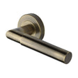This is an image of a Heritage Brass - Door Handle Lever Latch on Round Rose Bauhaus Mitre Design Antique, v2270-at that is available to order from T.H Wiggans Ironmongery in Kendal.