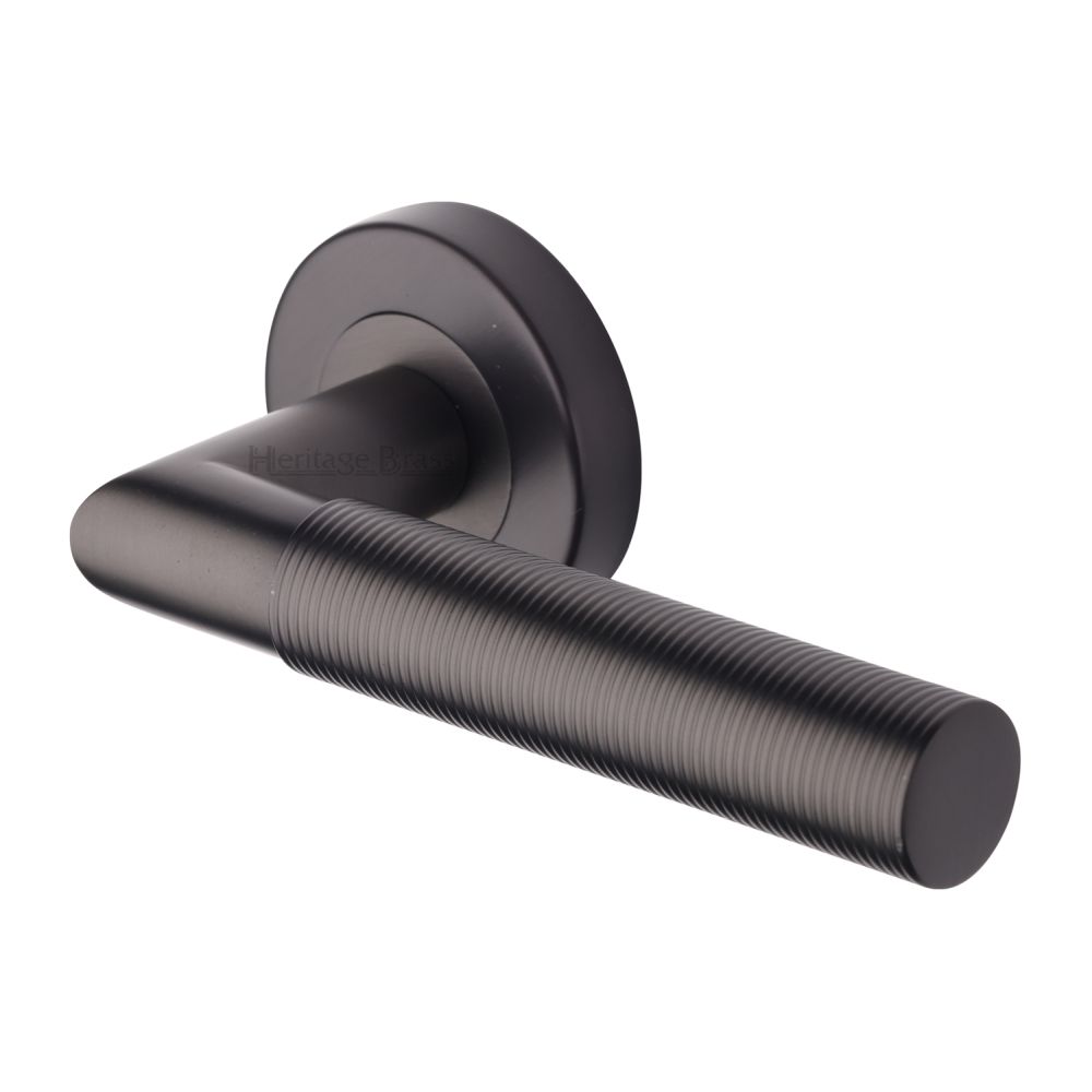 This is an image of a Heritage Brass - Door Handle Lever Latch on Round Rose Bauhaus Mitre Reeded Desi, v2274-mb that is available to order from T.H Wiggans Ironmongery in Kendal.