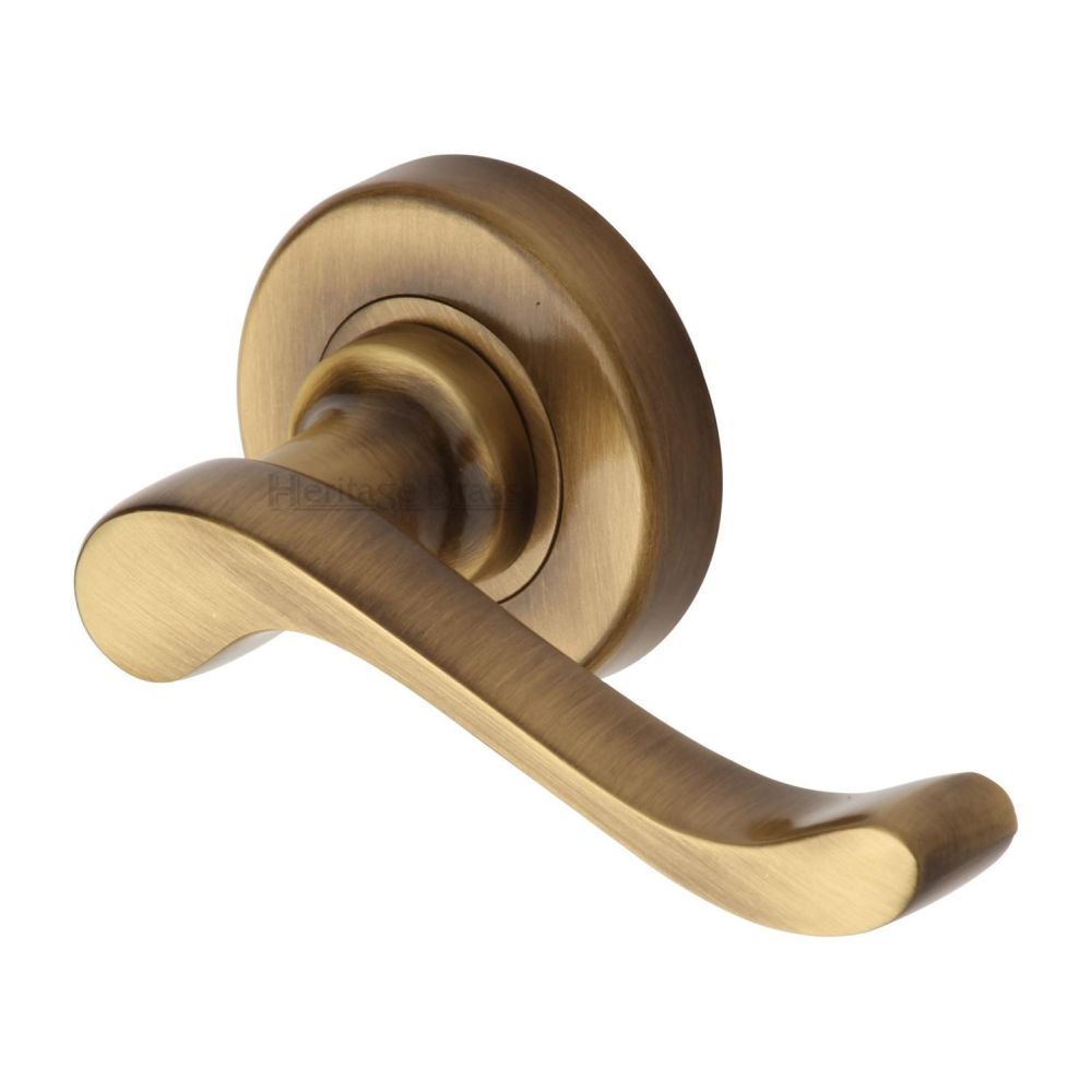 This is an image of a Heritage Brass - Door Handle Lever Latch on 53mm Round Rose Bedford Design Antique, v3010-at that is available to order from T.H Wiggans Ironmongery in Kendal.