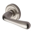 This is an image of a Heritage Brass - Door Handle Lever Latch on Round Rose Charlbury Design Satin Nic, v3020-sn that is available to order from T.H Wiggans Ironmongery in Kendal.