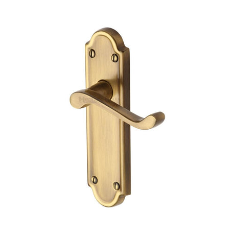 This is an image of a Heritage Brass - Door Handle Lever Latch Meridian Design Antique Brass Finish, v313-at that is available to order from T.H Wiggans Ironmongery in Kendal.
