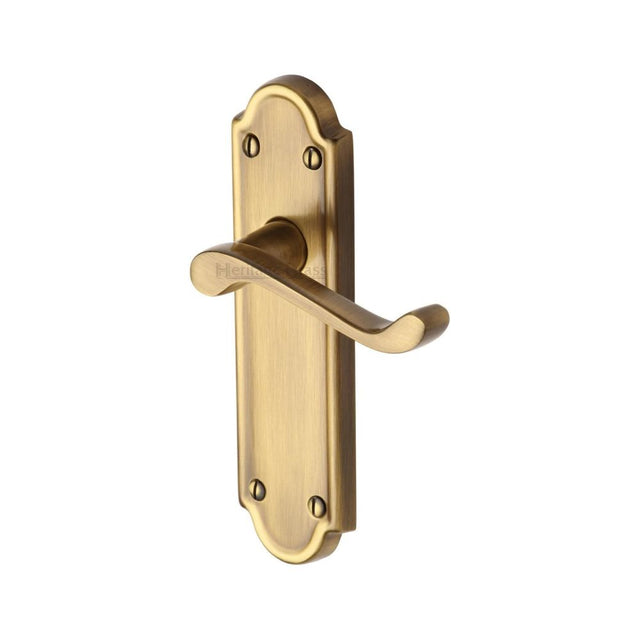 This is an image of a Heritage Brass - Door Handle Lever Latch Meridian Design Antique Brass Finish, v313-at that is available to order from T.H Wiggans Ironmongery in Kendal.