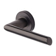 This is an image of a Heritage Brass - Door Handle Lever Latch on Round Rose Mercury Design Matt Bronz, v3262-mb that is available to order from T.H Wiggans Ironmongery in Kendal.