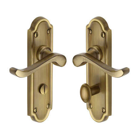 This is an image of a Heritage Brass - Door Handle for Bathroom Meridian Design Antique Brass Finish, v330-at that is available to order from T.H Wiggans Ironmongery in Kendal.