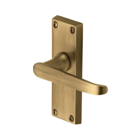 This is an image of a Heritage Brass - Door Handle Lever Latch Victoria Short Design Antique Brass Finish, v3910-at that is available to order from T.H Wiggans Ironmongery in Kendal.