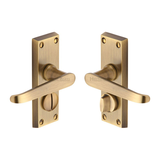 This is an image of a Heritage Brass - Door Handle for Privacy Set Victoria Short Design Antique Brass Fi, v3935-at that is available to order from T.H Wiggans Ironmongery in Kendal.