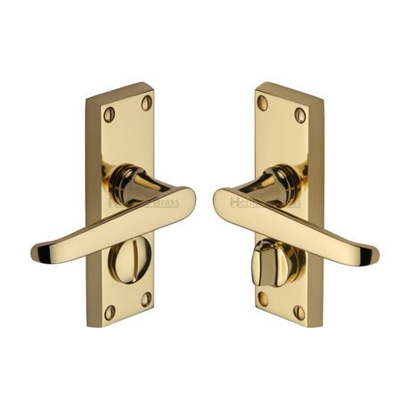 This is an image of a Heritage Brass - Door Handle for Privacy Set Victoria Short Design Polished Brass Fi, v3935-pb that is available to order from T.H Wiggans Ironmongery in Kendal.