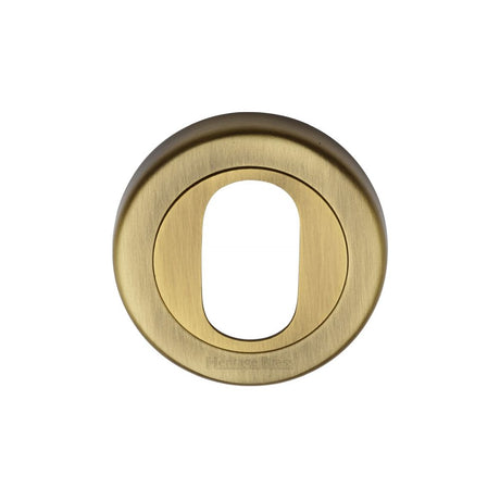 This is an image of a Heritage Brass - Oval Profile Cylinder Escutcheon Antique Brass Finish, v4010-at that is available to order from T.H Wiggans Ironmongery in Kendal.