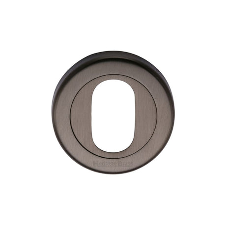 This is an image of a Heritage Brass - Oval Profile Cylinder Escutcheon Matt Bronze Finish, v4010-mb that is available to order from T.H Wiggans Ironmongery in Kendal.