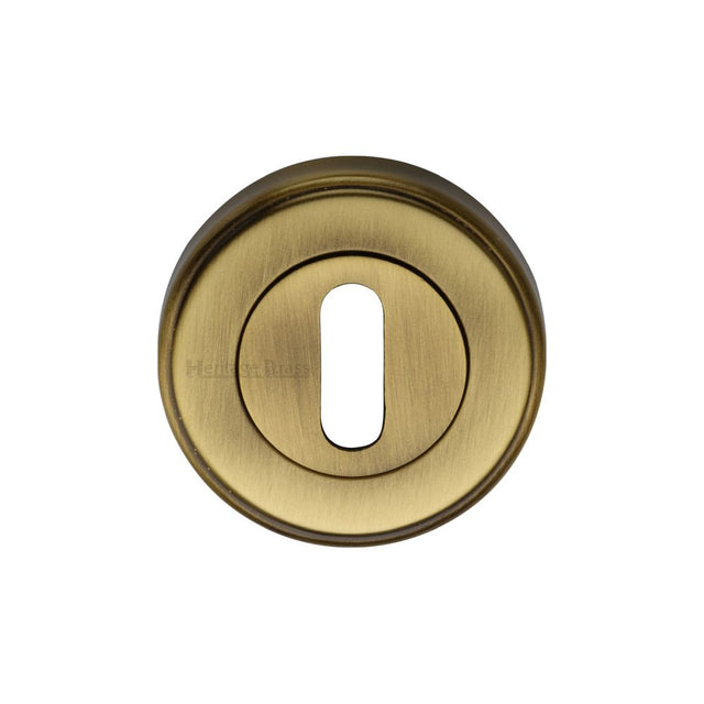 This is an image of a Heritage Brass - Key Escutcheon Antique Brass Finish, v5000-at that is available to order from T.H Wiggans Ironmongery in Kendal.