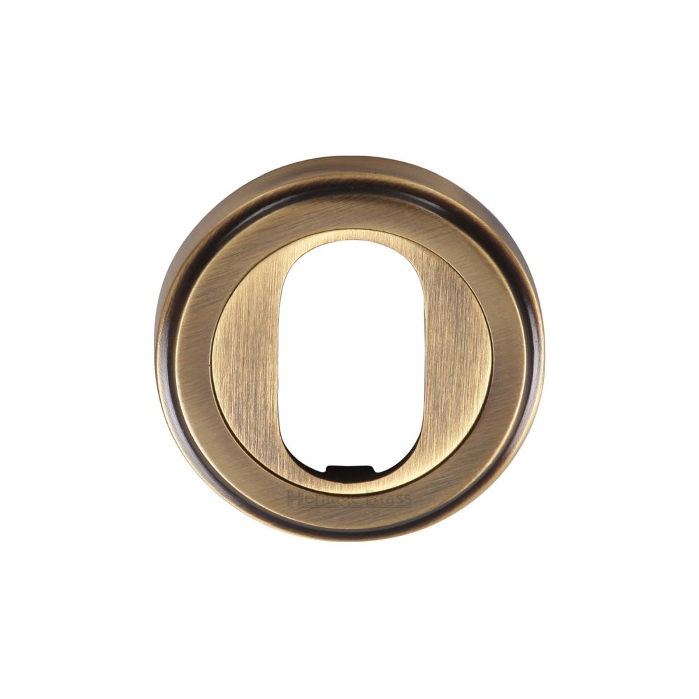 This is an image of a Heritage Brass - Oval Profile Cylinder Escutcheon Antique Brass Finish, v5010-at that is available to order from T.H Wiggans Ironmongery in Kendal.