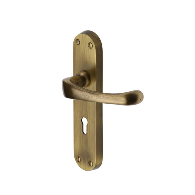 This is an image of a Heritage Brass - Door Handle Lever Lock Gloucester Design Antique Brass Finish, v6050-at that is available to order from T.H Wiggans Ironmongery in Kendal.