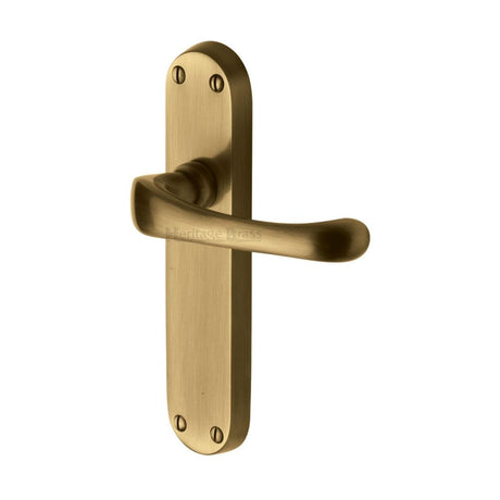 This is an image of a Heritage Brass - Door Handle Lever Latch Gloucester Design Antique Brass Finish, v6060-at that is available to order from T.H Wiggans Ironmongery in Kendal.