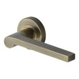 This is an image of a Heritage Brass - Door Handle Lever Latch on Round Rose Metro Mid Century Design, v6225-at that is available to order from T.H Wiggans Ironmongery in Kendal.