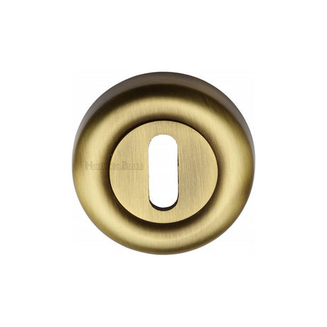 This is an image of a Heritage Brass - Key Escutcheon Antique Brass Finish, v6722-at that is available to order from T.H Wiggans Ironmongery in Kendal.