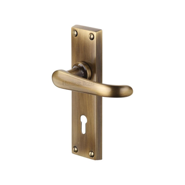 This is an image of a Heritage Brass - Door Handle Lever Lock Windsor Design Antique Brass Finish, v700-at that is available to order from T.H Wiggans Ironmongery in Kendal.