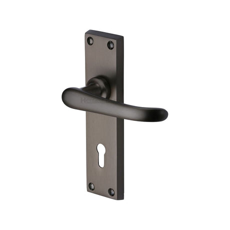 This is an image of a Heritage Brass - Door Handle Lever Lock Windsor Design Matt Bronze Finish, v700-mb that is available to order from T.H Wiggans Ironmongery in Kendal.