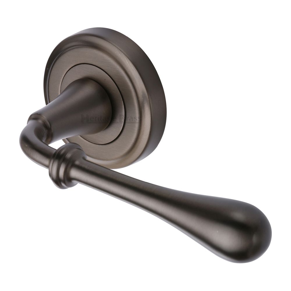 This is an image of a Heritage Brass - Door Handle Lever Latch on Round Rose Roma Design Matt Bronze F, v7155-mb that is available to order from T.H Wiggans Ironmongery in Kendal.