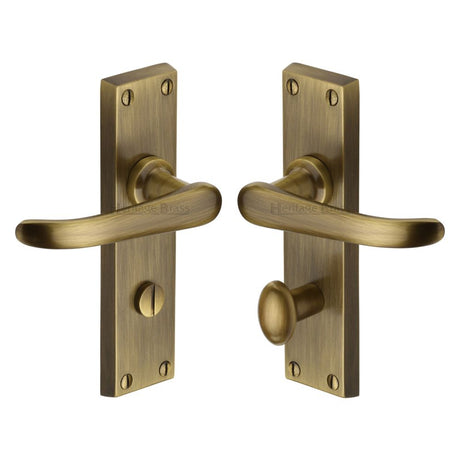 This is an image of a Heritage Brass - Door Handle for Bathroom Windsor Design Antique Brass Finish, v730-at that is available to order from T.H Wiggans Ironmongery in Kendal.