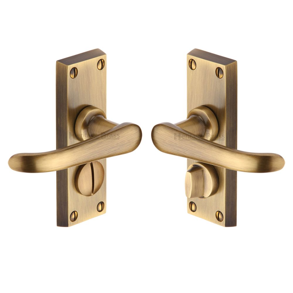 This is an image of a Heritage Brass - Door Handle for Privacy Set Windsor Short Design Antique Brass Fin, v735-at that is available to order from T.H Wiggans Ironmongery in Kendal.