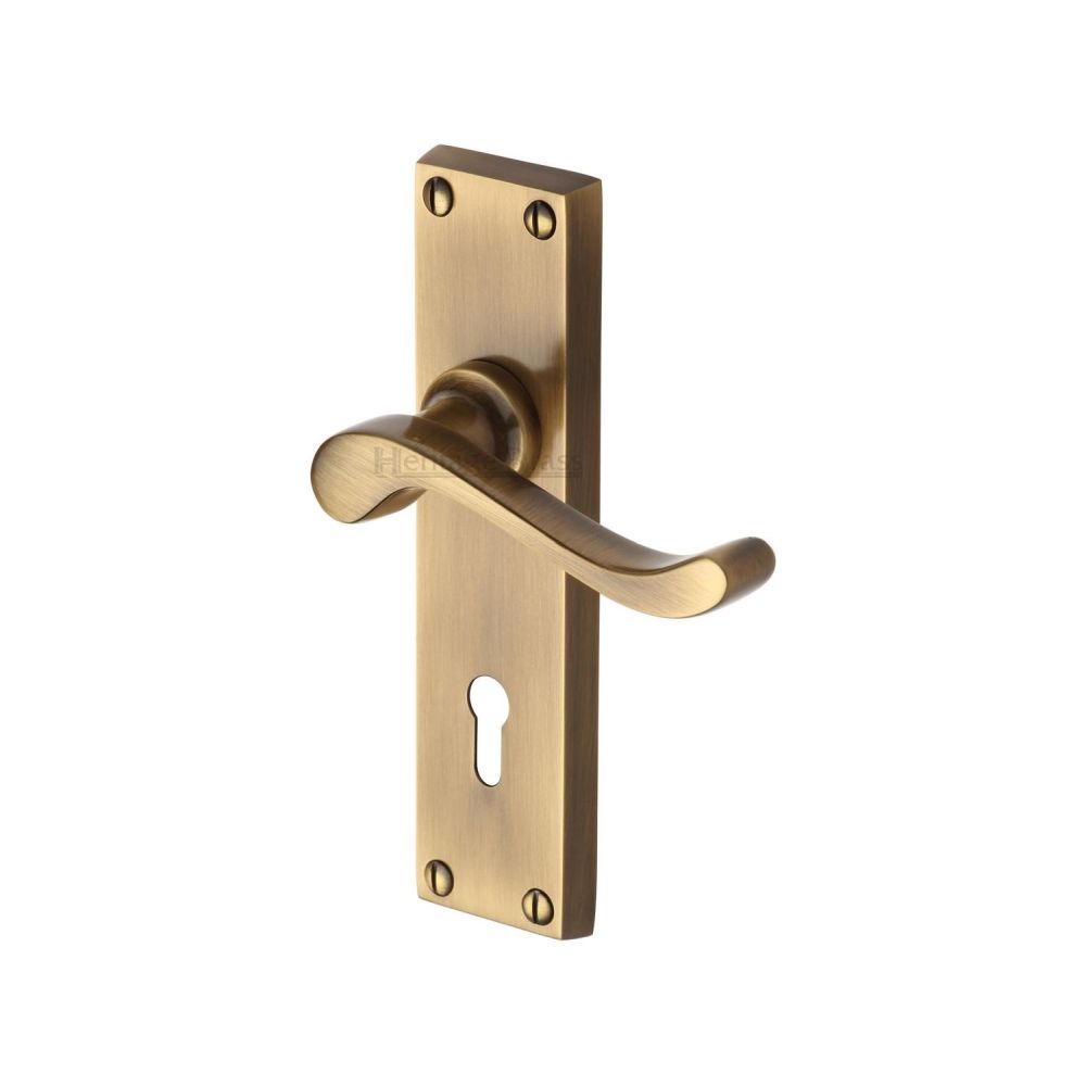 This is an image of a Heritage Brass - Door Handle Lever Lock Bedford Design Antique Brass Finish, v810-at that is available to order from T.H Wiggans Ironmongery in Kendal.