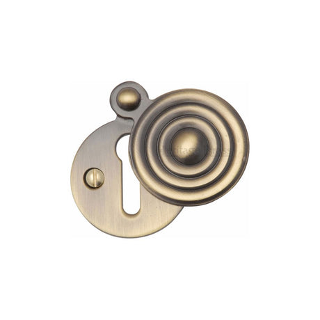 This is an image of a Heritage Brass - Covered Keyhole Reeded Antique Brass Finish, v972-at that is available to order from T.H Wiggans Ironmongery in Kendal.