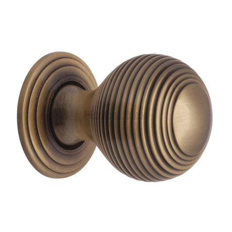 This is an image of a Heritage Brass - Cabinet Knob Reeded Design 32mm Antique Brass Finish, v973-32-at that is available to order from T.H Wiggans Ironmongery in Kendal.