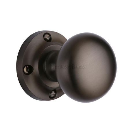 This is an image of a Heritage Brass - Mortice Knob on Rose Victoria Design Matt Bronze Finish, v980-mb that is available to order from T.H Wiggans Ironmongery in Kendal.