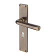 This is an image of a Heritage Brass - Octave Lever Lock Door Handle on 200mm Plate Antique Brass finish, vt5900-at that is available to order from T.H Wiggans Ironmongery in Kendal.