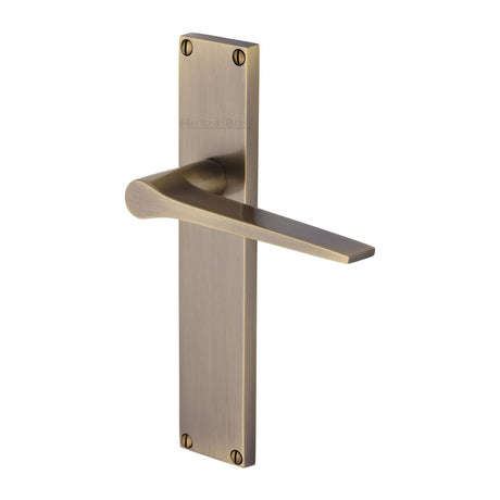 This is an image of a Heritage Brass - Gio Lever Latch Door Handle on 200mm Plate Antique Brass finish, vt8110-at that is available to order from T.H Wiggans Ironmongery in Kendal.