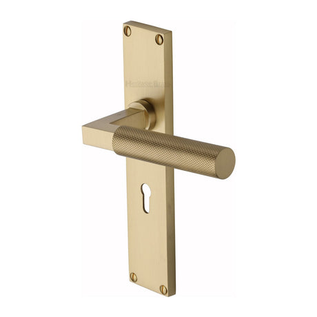 This is an image of a Heritage Brass - Bauhaus Knurled Lever Lock Door Handle on 200mm Plate Satin Brass finish, vt9300-sb that is available to order from T.H Wiggans Ironmongery in Kendal.