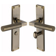 This is an image of a Heritage Brass - Bauhaus Knurled Bathroom Set Door Handle on 200mm Plate Antique Brass finish, vt9330-at that is available to order from T.H Wiggans Ironmongery in Kendal.