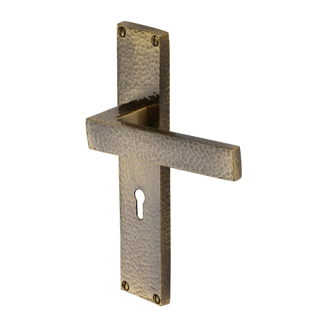 This is an image of a Heritage Brass - Delta Hammered Lever Lock Door Handle on 200mm Plate Antique Brass finish, vth3300-at that is available to order from T.H Wiggans Ironmongery in Kendal.