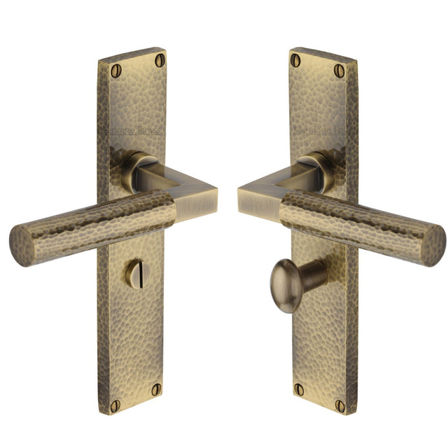 This is an image of a Heritage Brass - Bauhaus Hammered Bathroom Set Door Handle on 200mm Plate Antique Brass finish, vth4330-at that is available to order from T.H Wiggans Ironmongery in Kendal.