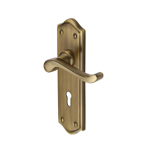 This is an image of a Heritage Brass - Door Handle Lever Lock Buckingham Design Antique Brass Finish, w4200-at that is available to order from T.H Wiggans Ironmongery in Kendal.