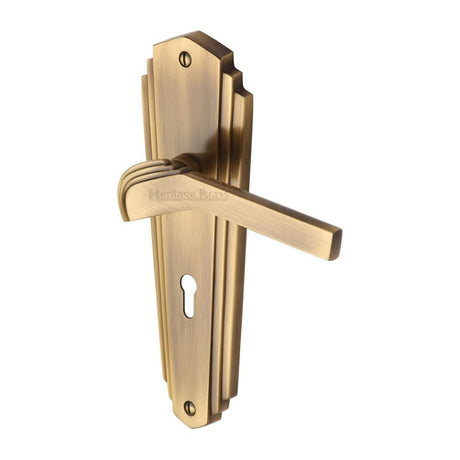 This is an image of a Heritage Brass - Door Handle Lever Lock Waldorf Design Antique Brass Finish, wal6500-at that is available to order from T.H Wiggans Ironmongery in Kendal.