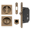 This is an image of Alexander & Wilks - Sliding Door Lock Set - Square Roses - Radius Forend & Strike-Antique Brass AW111RAB available to order from T.H. Wiggans Ironmongery in Kendal, quick delivery and discounted prices.