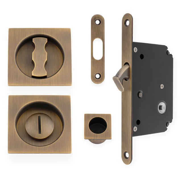 This is an image of Alexander & Wilks - Sliding Door Lock Set - Square Roses - Radius Forend & Strike-Antique Brass AW111RAB available to order from T.H. Wiggans Ironmongery in Kendal, quick delivery and discounted prices.