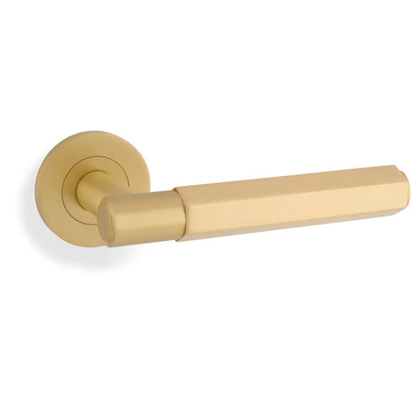 This is an image showing Alexander & Wilks - Spitfire Hex Lever on Round Rose - Satin Brass aw224sb available to order from T.H. Wiggans Ironmongery in Kendal, quick delivery and discounted prices.