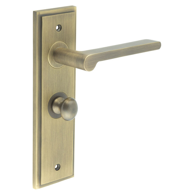 This is an image showing the Frelan - Fitzrovia Door Handle Bathroom Backplate Antique Brass & Turn & Release available to order from T.H. Wiggans Ironmongery in Kendal